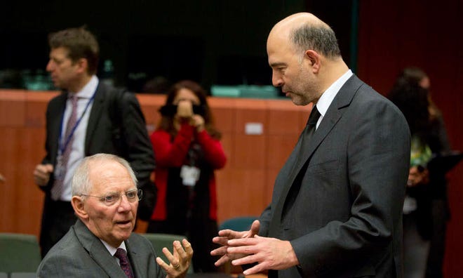 Pierre Moscovici (right), the European commissioner for economic affairs, talks to German Finance Minister Wolfgang Schaeuble. Germany showed less flexibility on talks with Greece on Monday.