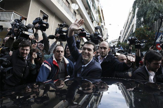 Alexis Tsipras, leader of Greece's left-wing Syriza party, waves to his supporters in Athens. At 40, he could become the youngest prime minister in 150 years.