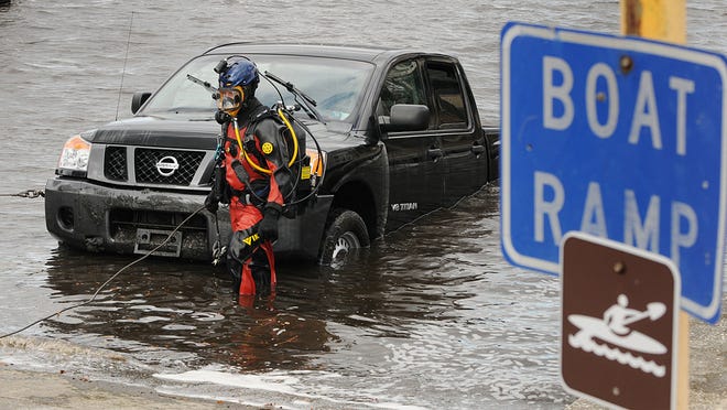 A pickup truck is seen in the waters of the St. Johns near the boat ramp at River City Brewing Co.
