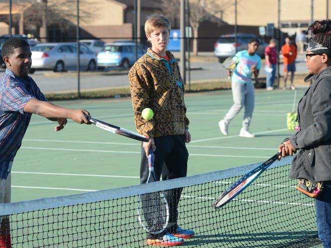 Spartanburg High School's Spencer Brown, center, created a program that gives children involved in the Boys and Girls Club of the Upstate the chance to learn to play tennis. Brown looks on as Temontai Dandy, left, and O'Shauna Ferguson hit a ball back and forth.