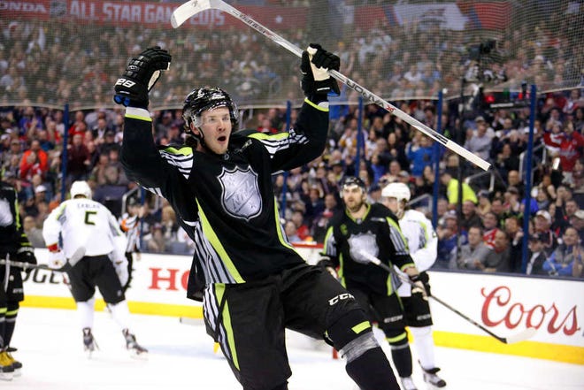 Team Foligno's Ryan Johansen of the Columbus Blue Jackets celebrates the first of his two first-period goals against Team Toews' goalie Roberto Luongo of the Florida Panthers during the NHL All-Star hockey game in Columbus, Ohio, Sunday, Jan. 25, 2015.(AP Photo/Gene J. Puskar)
