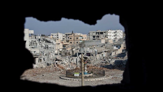 Associated Press file photoAn area controlled by the Islamic State group, past the Qada Azadi roundabout, foreground, is shown in November 2014 in Kobani, Syria.