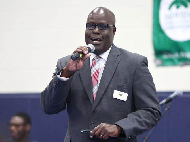 In this Aug. 9, 2014 file Deputy Superintendent of Schools Hershel Lyons talks with students and their parents during the 2014 Back to School Stop the Violence Rally held at the Santa Fe College gym in Gainesville.
