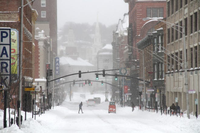 People start to venture out on Washington Street in downtown Providence Tuesday.