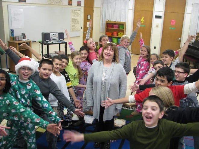 Marianne Oien, pictured with some of her music students at Quinn Elementary School in Dartmouth, is the SouthCoast Teacher of the Year. CONTRIBUTED PHOTO