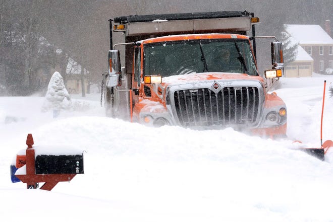 A snowplow clears a side road in Colchester Tuesday during a blizzard.  

John Shishmanian/ NorwichBulletin.com