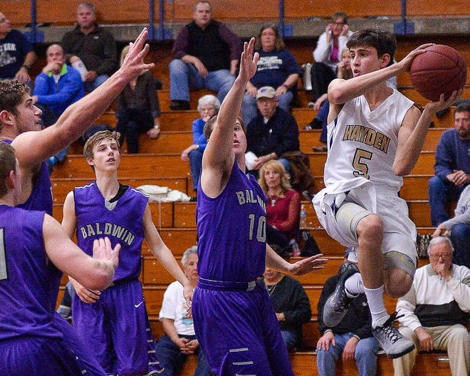 Hayden's Ryan Anderson leaps to make a pass against Baldwin on Tuesday night at Hayden.