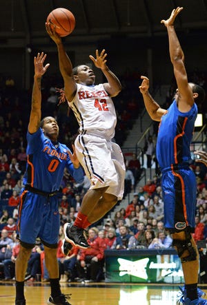 Mississippi guard Stefan Moody shoots between Florida guard Kasey Hill, left, and forward Jon Horford during the first half of Saturday's game in Oxford, Miss., a 72-71 Gator defeat. (AP Photo/The Daily Mississippian, Payton Teffner)