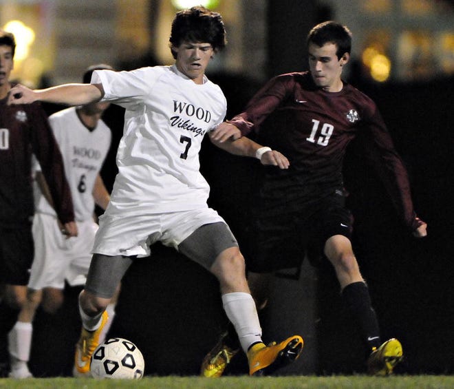 FILE PHOTO - Archbishop Wood midfielder Dan McDonald (7) and St. Joe's Prep's Chris Hibbs (19) battle for possession in the second half during a PCL boys soccer quarterfinal at Veterans Field in Upper Southampton in October 2014.