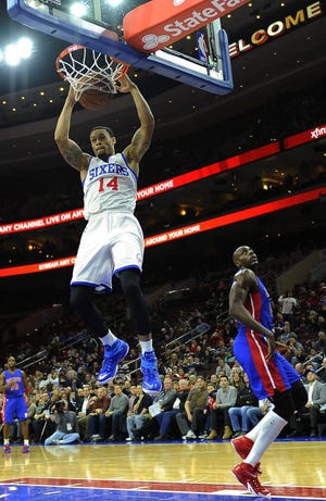 The 76ers' K.J. McDaniels (14) dunks in a Jan. 28 game against the Pistons.
