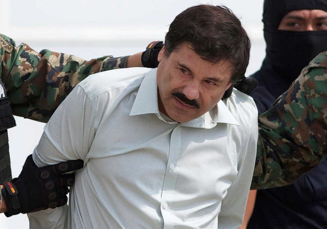 Associated Press file photo. Joaquin "El Chapo" Guzman, the head of Mexico's Sinaloa Cartel, is escorted to a helicopter in February 2014 in Mexico City following his capture overnight in the beach resort town of Mazatlan.-AP