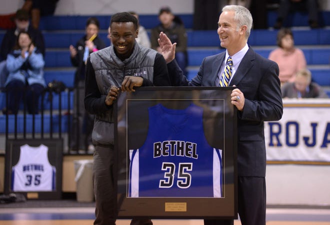 Former Bethel Christian Academy star, and current Lenoir Community College freshman, Davon Edwards reacts as his accolades are read during a ceremony with coach Bert Potter retiring his Bethel No. 35 on Tuesday.