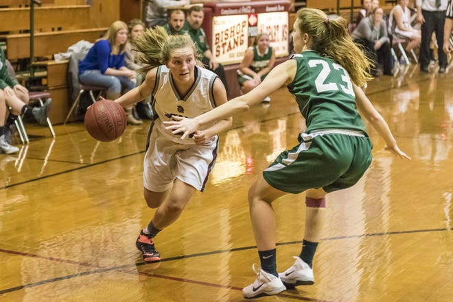 Bishop Stang's Abby Means drives against Dartmouth captain Kelly McManus during Friday's game at Stang. RYAN FEENEY/CHRONICLE