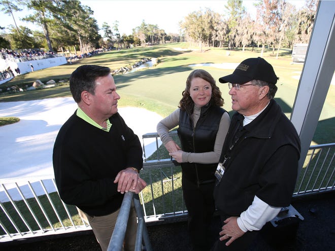 Mike Cooney, left, director of golf at Golden Ocala, talks with Mollie and Randy Coates on Wednesday in the skybox overlooking the 18th green on the Ocala course, where the Coates Golf Championship is being played.