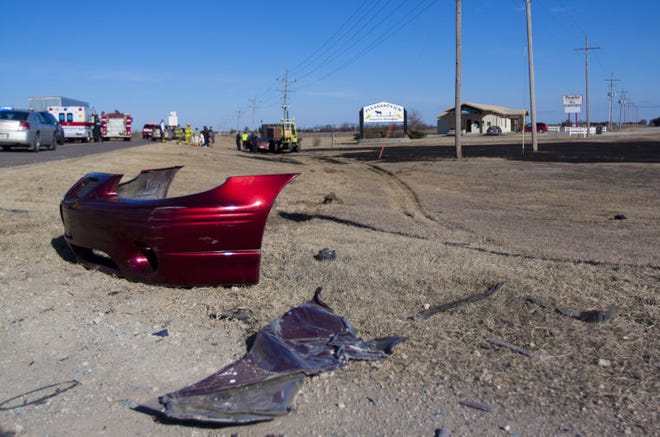 The front bumper of the red Pontiac Firebird was torn off after colliding with a Semi-Trailer on U.S 50 around 2:45 in front of the Pleasant View shopping center on January 29, 2015. A trail of debris and skid marks were left behind from the crash.