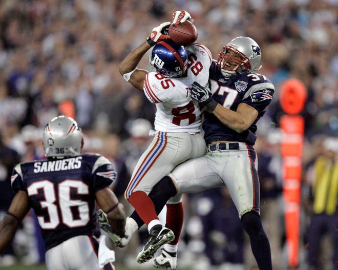 FILE - In this Feb. 3, 2008, file photo, New York Giants receiver David Tyree (85) catches a pass while in the clutches of New England Patriots safety Rodney Harrison (37) as James Sanders (36) watches during the fourth quarter of the Super Bowl XLII football game in Glendale, Ariz. A win Sunday night, Feb 1, against the Seattle Seahawks would even the Patriots record in Super Bowls at University of Phoenix Stadium at 1-1. New England is seeking a championship, not closure for its 17-14 loss to the New York Giants in 2008. (AP Photo/Gene Puskar, File)