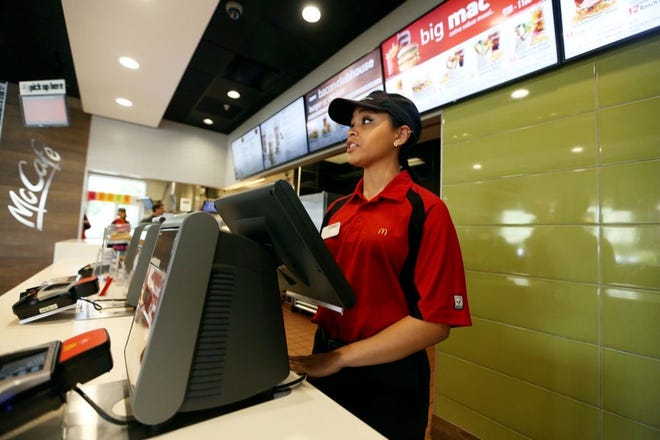 YADINIL RIVERA, 17, takes an order at the McDonald's on U.S. 98 South in Lakeland. The world's biggest hamburger chain is facing an onslaught of competition from all directions.
