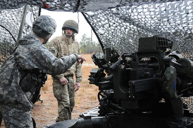 An American artillery paratrooper demonstrates the capabilities of the M119A3 to his British counterpart during Operation Pegasus Cypher at Fort Bragg. The interoperability exercise between 2nd Battalion, 319th Airborne Field Artillery Regiment, 2nd Brigade Combat Team, 82nd Airborne Division and 7th Parachute Regiment, Royal Horse Artillery created a shared understanding of the different operating capabilities between the two nations.