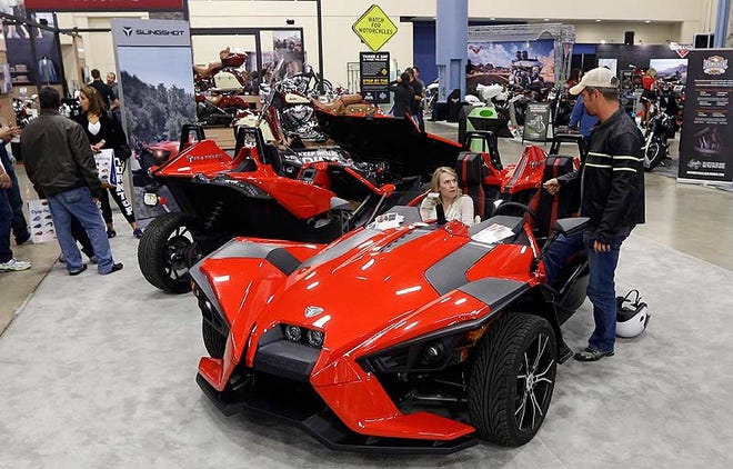 Visitors check out a three wheel Polaris Slingshot earlier this month at a motorcycle show at the Miami Beach Convention Center in Miami Beach, Fla.
