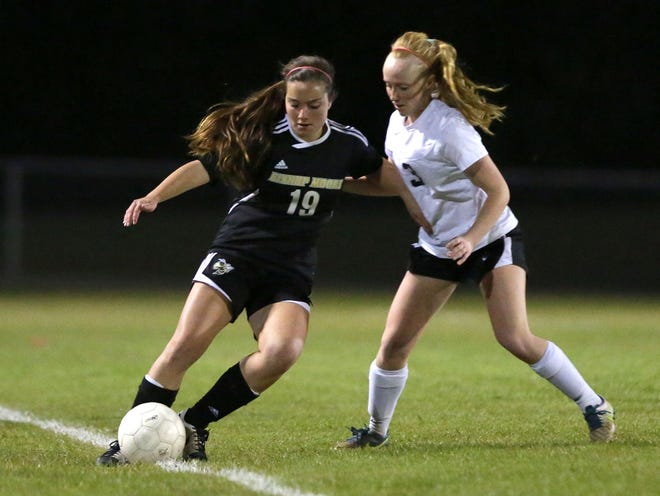 Bishop Moore's Victoria Bubrick keeps the ball away from Santa Fe's Summer Bromenschenkel. The Raiders' season ended with a 6-0 loss.
