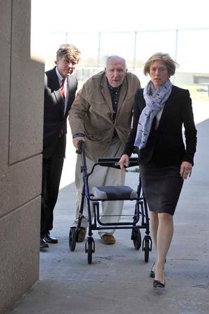 Stanley Marsh 3, center, is escorted into the Potter County Detention Center on Apr. 11, 2013 by his attorneys Paul Nugent, left, and Heather Peterson.