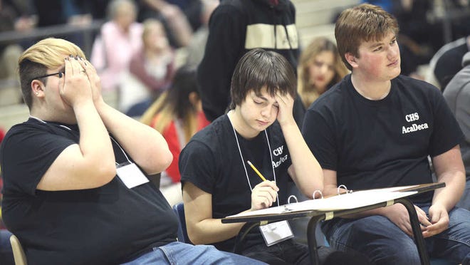 From left, Coronado High School's Patric Saran, Raymond Hernandez, and Tucker Matis answer at question during the Super Quiz Relay portion of the Region I Academic Decathlon, held at Monterey High School in Lubbock on Saturday. (Allison Terry/AJ Media)