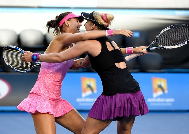 Bethanie Mattek-Sands of the U.S., right, and Lucie Safarova of the Czech Republic hug after defeating Taiwan's Chan Yung-jan and China's Zheng Jie in their women's doubles final at the Australian Open tennis championship in Melbourne, Australia, Friday, Jan. 30, 2015. (AP Photo/Andy Brownbill)