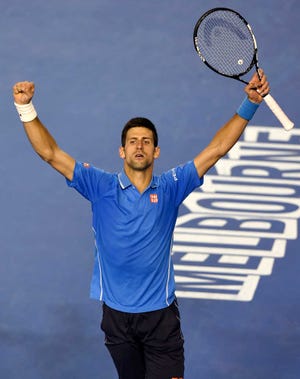 Novak Djokovic of Serbia celebrates after defeating Stan Wawrinka of Switzerland in their semifinal at the Australian Open tennis championship in Melbourne, Australia, Friday, Jan. 30, 2015. (AP Photo/Andy Brownbill)