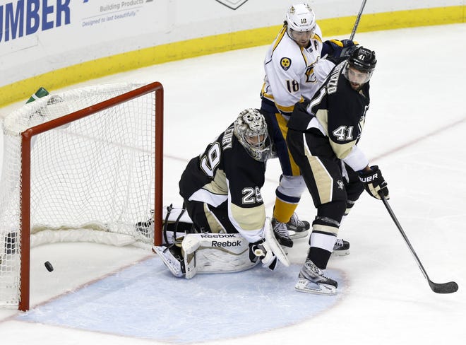 A shot by Predators' Mike Fisher gets by Penguins goalie Marc-Andre Fleury (29) as Predators' James Neal (18) is pinched between Penguins' Robert Bortuzzo (41) and Fleury in the third period of Sunday's game. The Predators won 4-0.