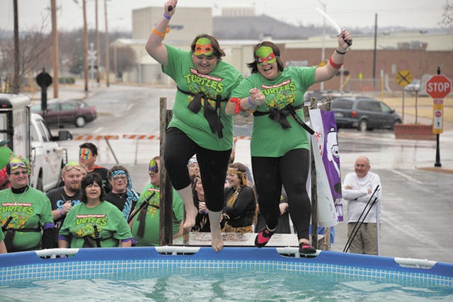 Two plungers representing the Vinita Hornets Special Olympics team propel themselves toward the chilly water during the Polar Plunge on Saturday. The popular event raises money and awareness for Special Olympics. Photo courtesy of Tracy Hammon