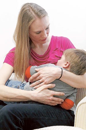 Heather Spada, breastfeeding peer counselor, feeds her son Colton, 19 months, as an example of what they teach in the breastfeeding class at the Onslow County Health Department in Jacksonville on Wednesday afternoon.