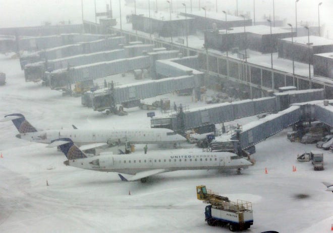 Snow blankets O'Hare International Airport, Sunday, Feb. 1, 2015, in Chicago. The first major winter storm of the year is bearing down on the Chicago region, bringing with it blizzard conditions of heavy snow and strong winds. More than 1,100 flights have been canceled at Chicago's airports and snow-covered roads are making travel treacherous. (AP Photo/Nam Y. Huh)