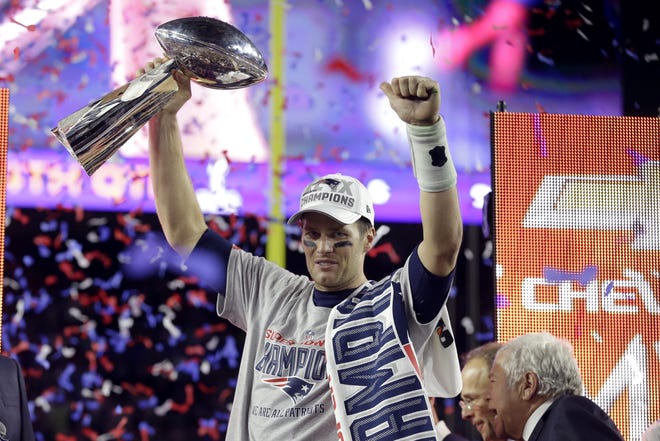 New England quarterback Tom Brady holds up the Vince Lombardi Trophy after the Patriots defeated the Seattle Seahawks 28-24 in Super Bowl XLIX on Sunday night in Glendale, Ariz. AP Photo/Michael Conroy
