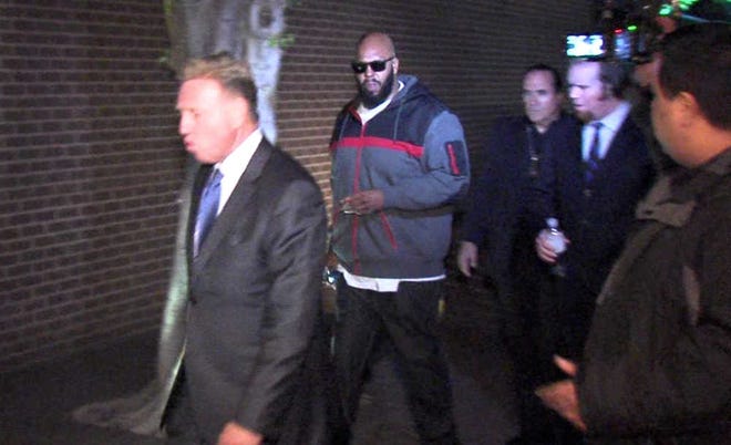 This image from video shows Death Row Records founder Marion "Suge" Knight, right, walking into the Los Angeles County Sheriffs department early Friday morning Jan. 30, 2015 in connection with a hit-and-run incident that left one man dead and another injured. (AP Photo/OnSceneVideo via AP Television)