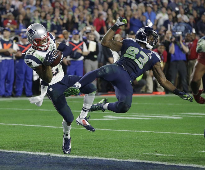 New England Patriots strong safety Malcolm Butler (21) intercepts a pass intended for Seattle Seahawks wide receiver Ricardo Lockette (83) during the second half of NFL Super Bowl XLIX football game Sunday, Feb. 1, 2015, in Glendale, Ariz. (AP Photo/Kathy Willens)