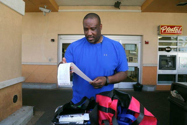 Former Miami Dolphins offensive lineman Keith Simms has an obsession off the field: coupon clipping. Simms looks over his savings after shopping with coupons at Publix in Feb. 2014 in Weston, Fla. He saved $144.83. (Mike Stocker/Sun Sentinel/TNS) 
 Former Miami Dolphins offensive lineman Keith Simms has an obsession off the field: coupon clipping. Simms looks over his savings after shopping with coupons at Publix in Feb. 2014 in Weston, Fla. He saved $144.83. (Mike Stocker/Sun Sentinel/TNS)