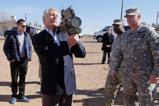 Secretary of Defense Chuck Hagel gets reacquainted with the Red Eye Air Defense System while touring Oro Grande, N.M., where he received his basic training in 1967. At right is Hagel's son Ziller Hagel.