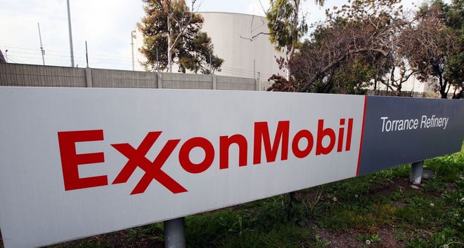 This Jan. 30, 2012, file photo, shows the sign for the ExxonMobil Torerance Refinery in Torrance, Calif. Exxon Mobile on Monday, Feb. 2, 2015, reported fourth-quarter earnings of $6.57 billion. (AP Photo/Reed Saxon, File)