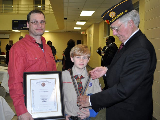 The Black Warrior Council of Boy Scouts of America held its annual Volunteer Recognition Banquet on Thursday. Cub Scout Benjamin Rose, center, received the American Legion Heroism Medal from Legionnaire Leroy McAbee Sr., right. At left is Benjamin's father, Matt Rose. Benjamin rescued a woman from drowning last year. The Heroism Medal is the most prestigious award given by the American Legion. This is the first time that the heroism award has been presented to a Cub Scout in Tuscaloosa.