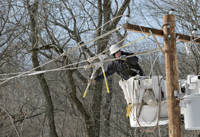 A PECO worker keeps busy Tuesday fixing wires that fell due to gusty winds in Wycombe Monday night causing three fires along Mill Creek Road including one at the new FOP lodge.