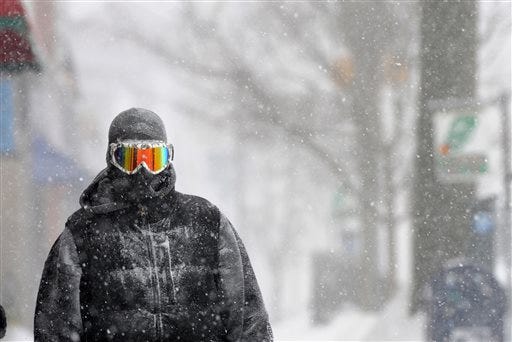 Guy Cournoyer of Northampton adds some color to an otherwise white-out day in downtown Northampton, Mass., Monday, Feb. 2, 2015. Cournoyer says the combination of ski goggles and a full head-covering balaclava leaves no exposed skin.