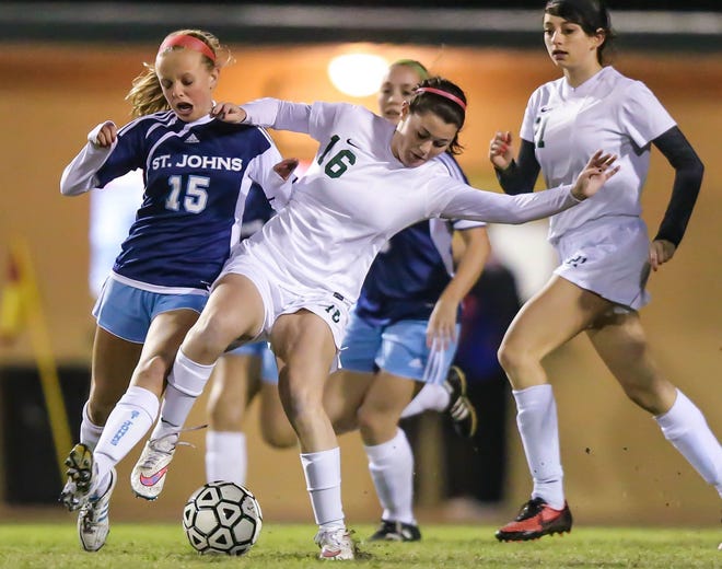 St. Johns Country Day's Payton Crews (15), left, and St. Joseph's Peyton Ortega (16) vie for control of the ball during the first half of high school girls soccer District 2, Class 1A final action at St. Joseph Academy in St. Augustine on Friday, January 16.