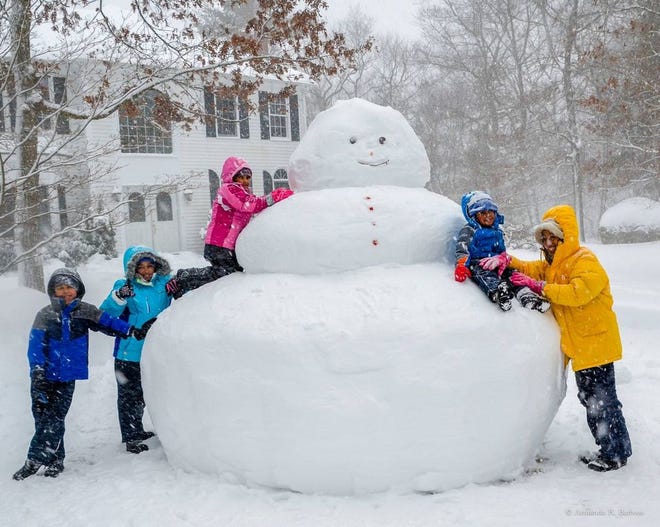 The Barbosa family in Stoughton with their outsized snowman on Monday, Feb. 2, 2015: Armando, Ariana, Angelica, Alex and Anna.