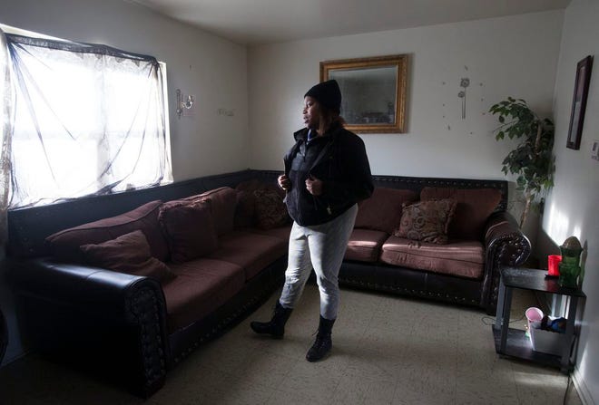 Erica Smith, 26, looks at the window of her apartment Wednesday, Jan. 29, 2015, at Fairgrounds Valley in Rockford. "It's really not bad if you keep it clean," she said.