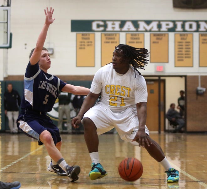 Crest's Malik Hopper goes up against East Burke's Jonas Bradshaw during Tuesday night's game at Crest.