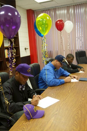 Former New Bern football players Cody Purdie, Shawn Best and Tavon Strayhorn signed their national letter-of-intent during last year's signing day. More area student-athletes will sign to play sports in college for Wednesday's National Signing Day.