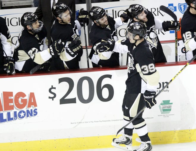 The Penguins' David Perron (39) is congratulated by the bench after his goal against the Canadiens during a January game.