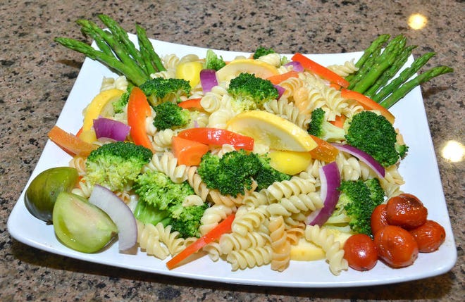Seasonal vegetable pasta primavera with lemongrass infused olive oil and citrus vinaigrette.