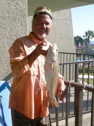 CONTRIBUTED Ernie Bjorkman with a 22-inch redfish he caught in the surf on St. Augustine Beach. He was tossing a spoon on light tackle, trying to hook-up with a couple of bluefish, but got a nice surprise with the fish of a different color.