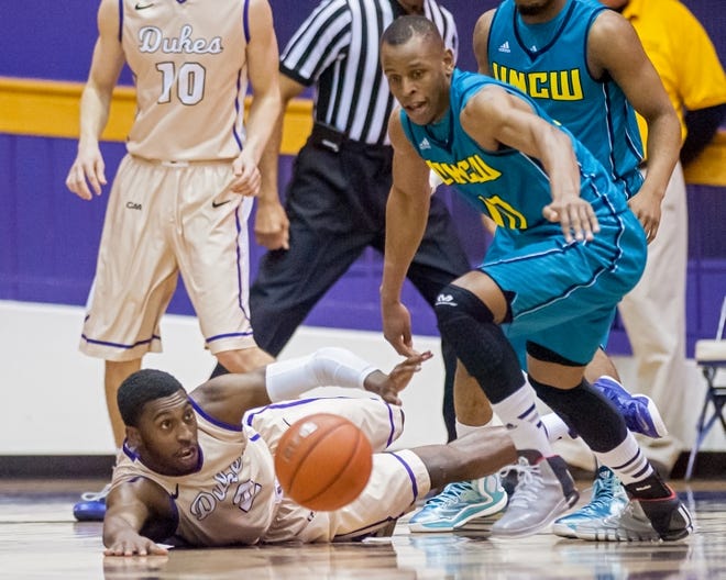 UNCW’s Freddie Jackson (center) scrambles for a loose ball against James Madison during the first half of a game in Harrisonburg, Va., on Wednesday, Feb. 4, 2015. Photo by Daniel Lin/Daily News-Record